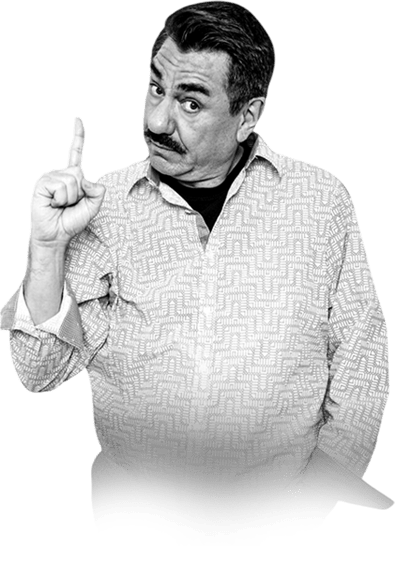 A man with a mustache gestures with one finger raised, signaling importance or a warning, in a patterned shirt against a transparent background.